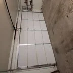 After - Insulated Garage Door Replacement with Modern Almond Raised Panel Design